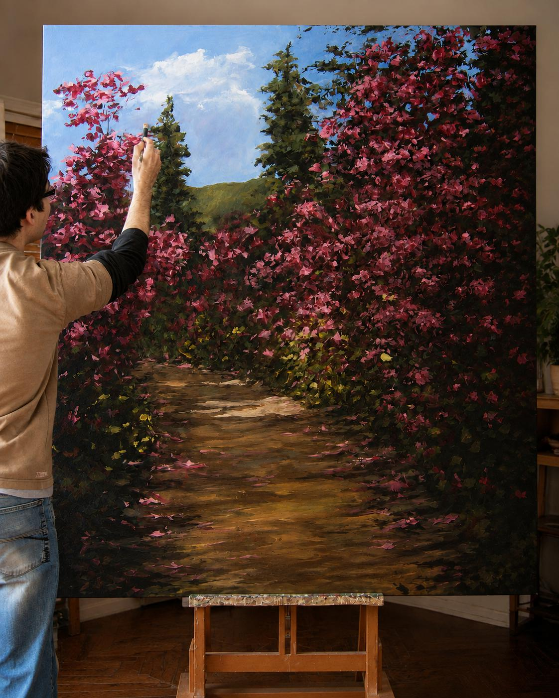 Tiago Garcia painting in oil at an easel — a road lined with azaleas in bloom